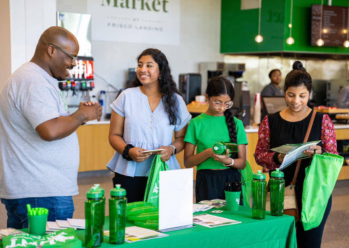 staff helping students at an event